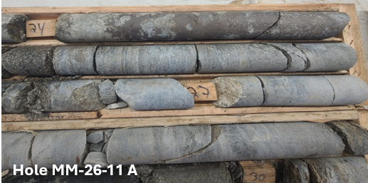 Drill core from ESGold hole MM-26-11 (photo A) in core boxes, showing altered rock with quartz-carbonate veining and visible sulphides